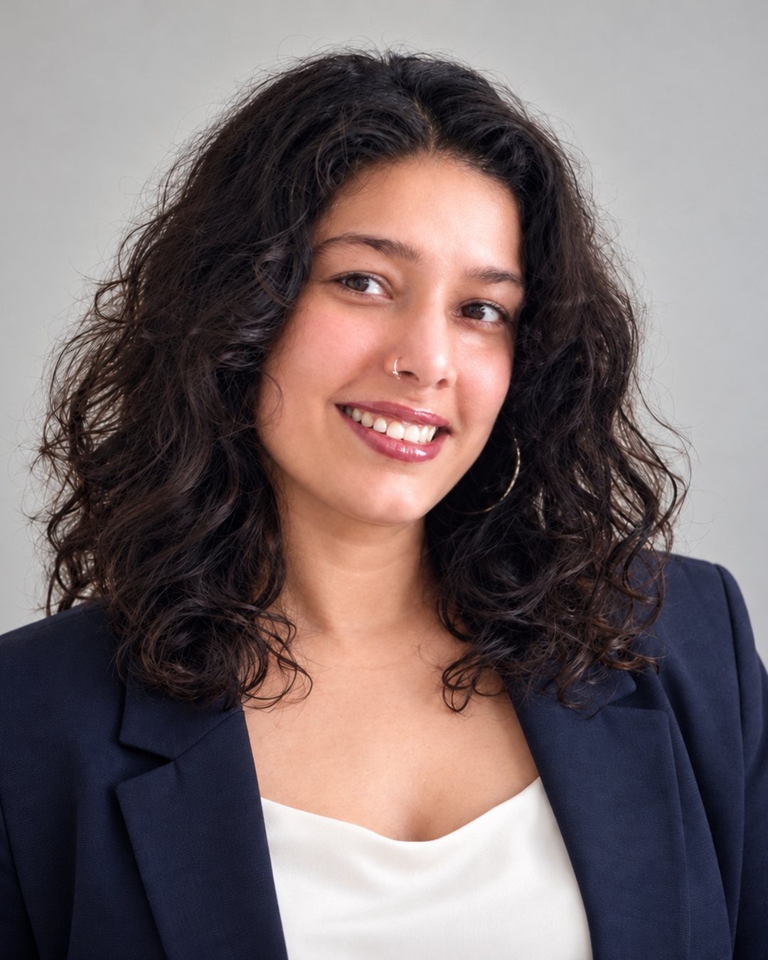 Lavi Bachchis, smiling, in a navy blazer
